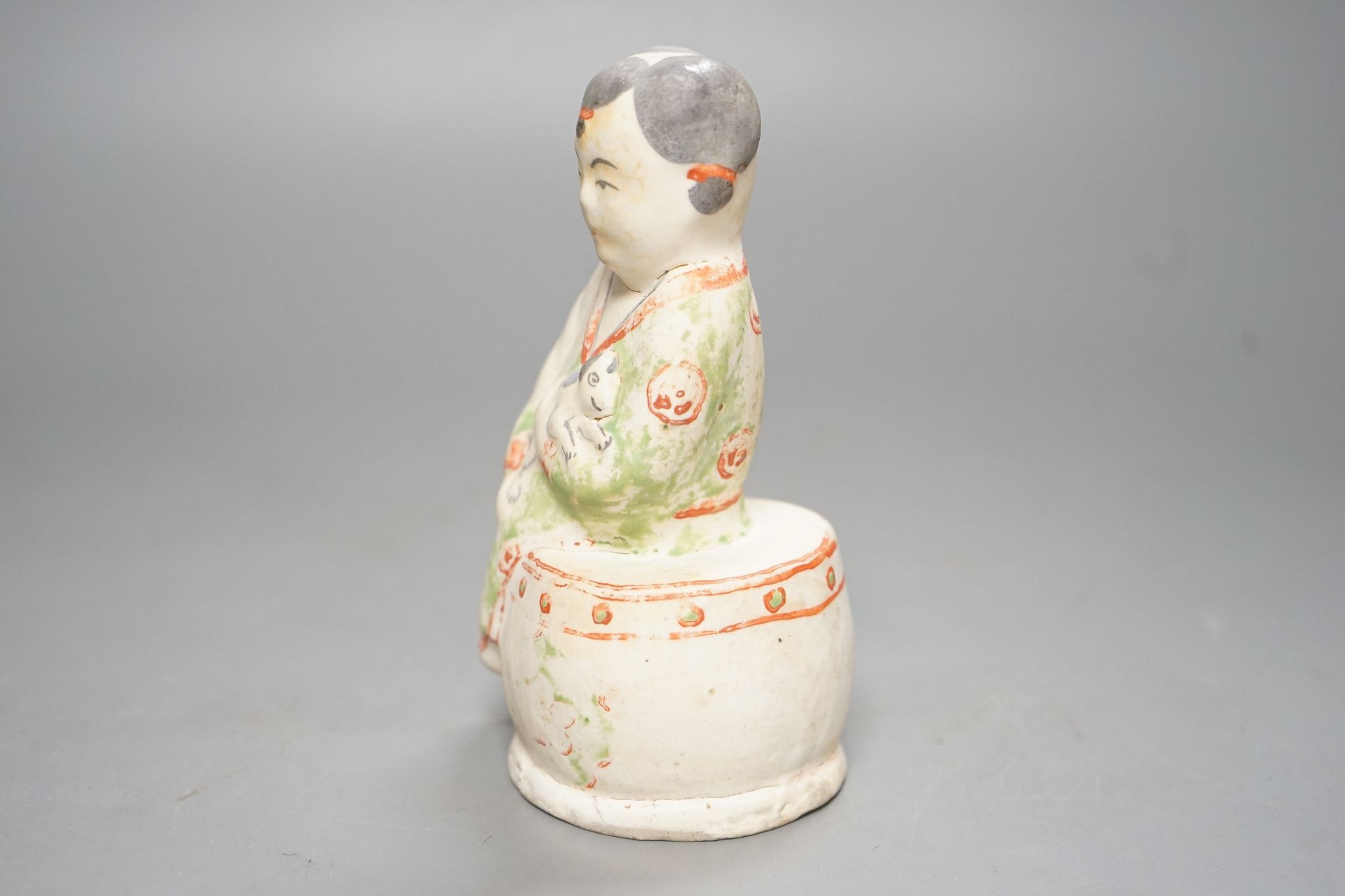 A Chinese Ming cizhou enamelled pottery group of a boy and dog, with case, 14cm